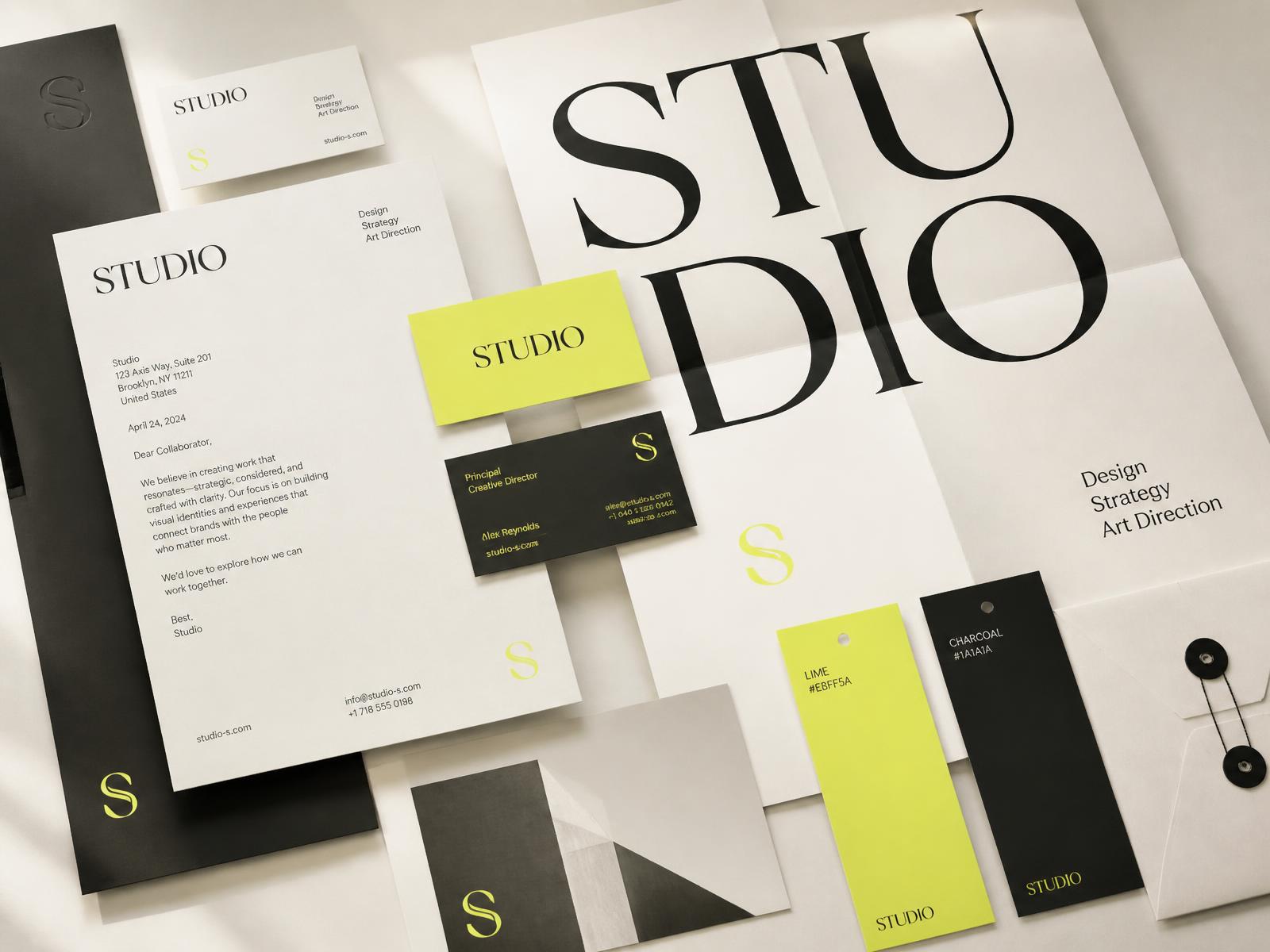 Editorial flat lay of a brand identity system — business cards, letterhead, color swatches